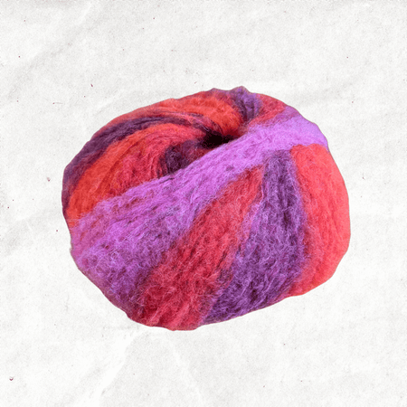 A fluffy ball of yarn with pink, purple, and red tones.