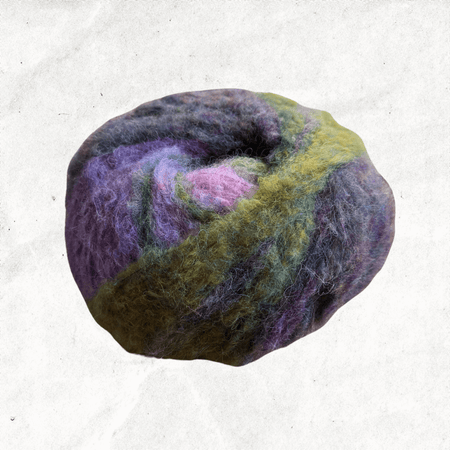 A fluffy ball of yarn with green, purple, and pink tones. The yarn is majority green.