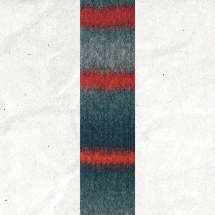 A yarn swatch showing the self striping pattern of the red, orange, and blue-grey tones.