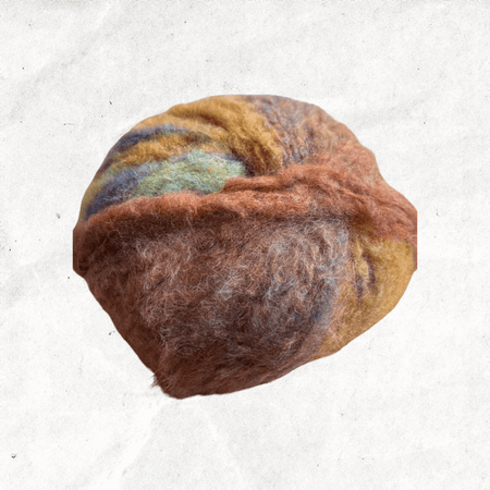 A fluffy ball of yarn with orange, brown, and teal tones.
